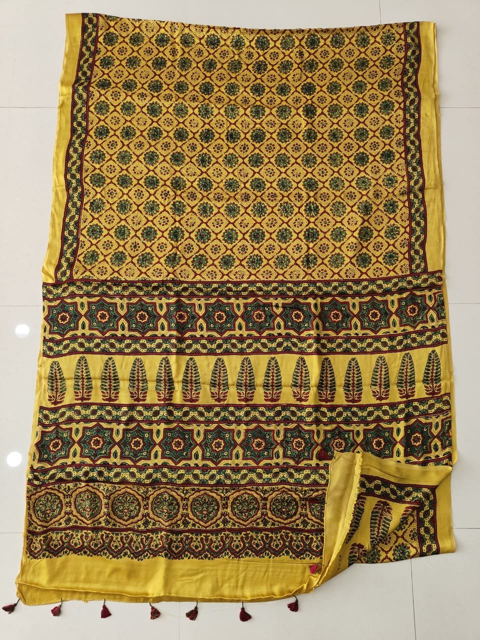 Yellow Ajrakh print pure Modal silk saree with green floral medallions and maroon tassels