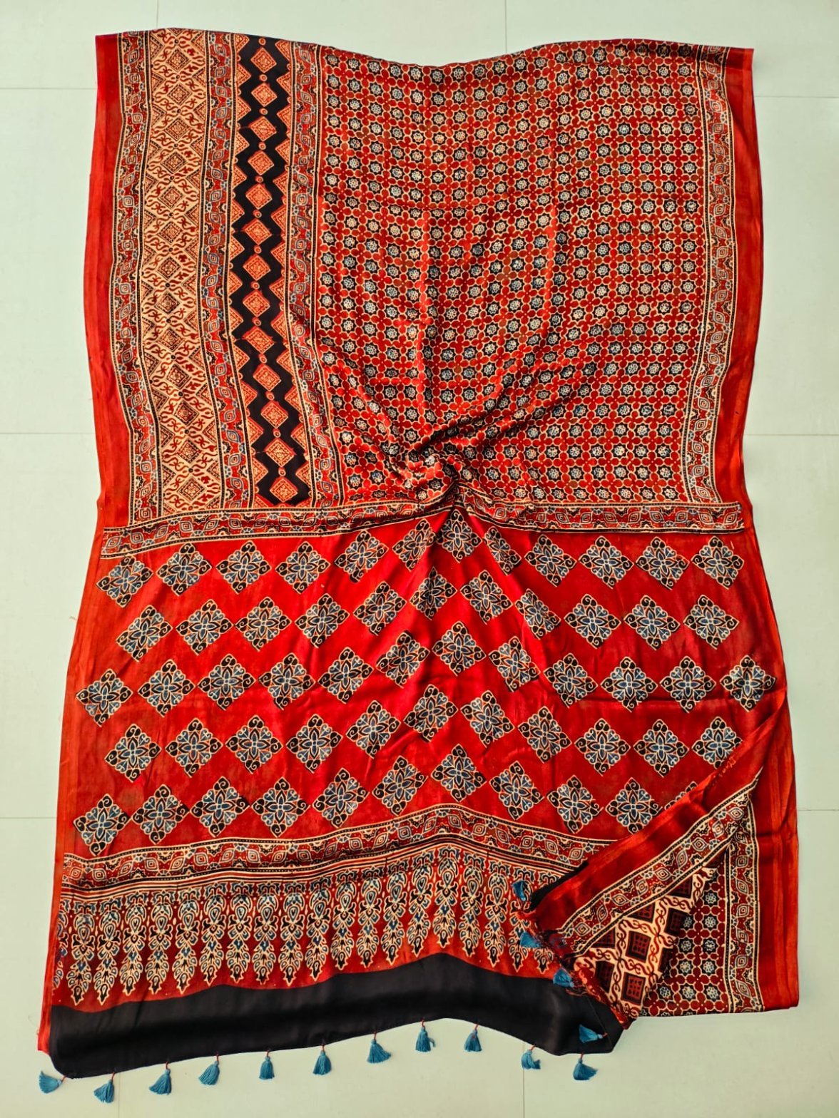 Red Ajrakh print pure Modal silk saree with diamond lattice motif and blue tassels