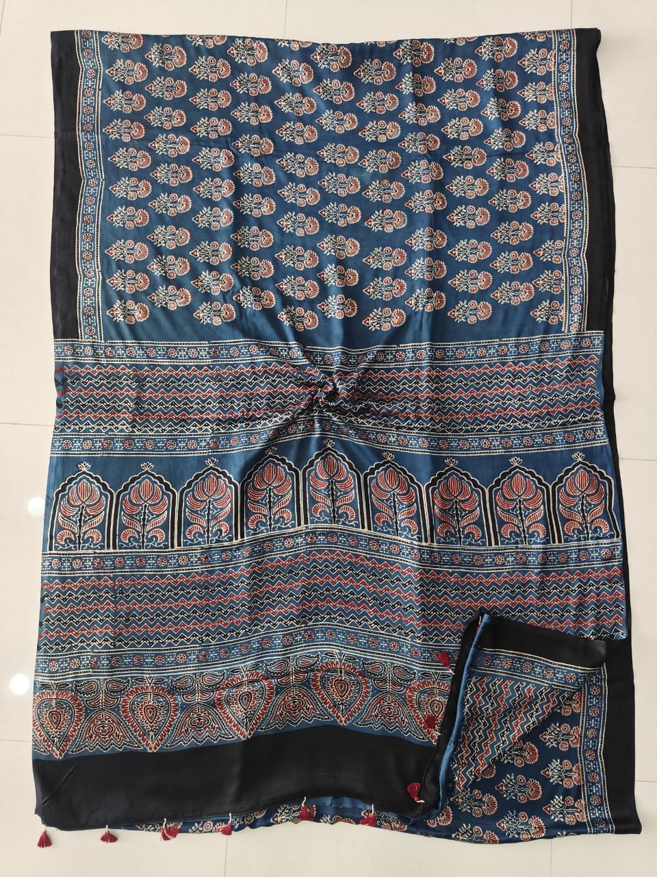 Indigo blue Ajrakh print silk saree with temple arch pallu and maroon tassels