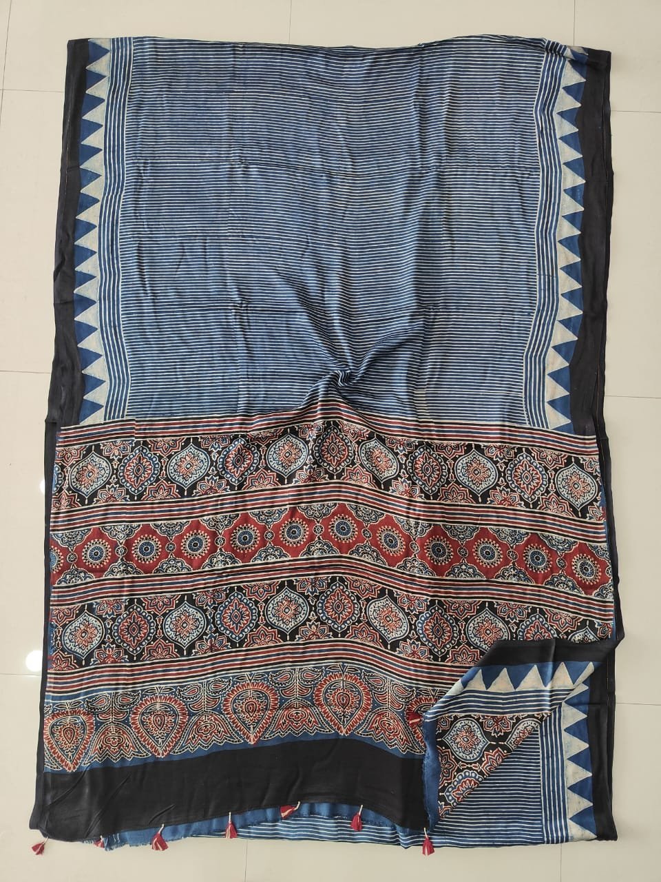 Indigo blue striped Ajrakh print Modal silk saree with medallion pallu and maroon tassels