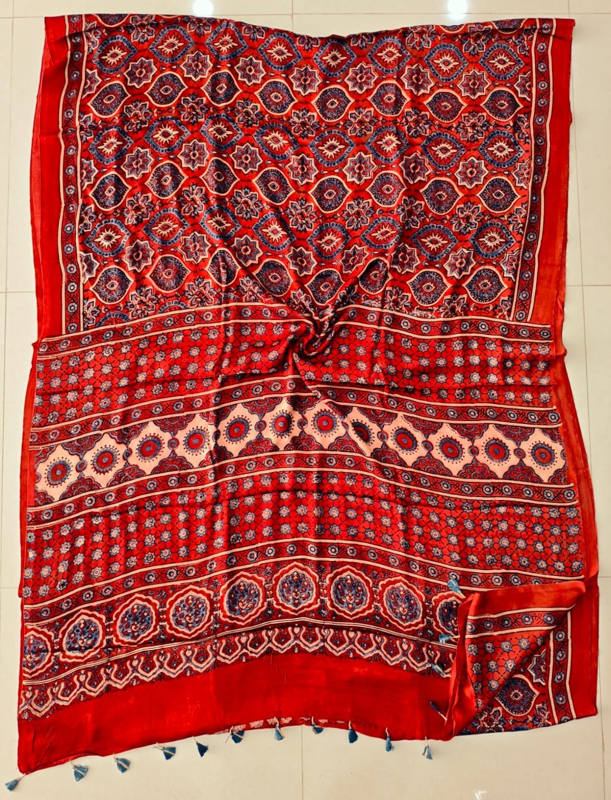 Red Ajrakh print pure modal silk saree with navy medallion lattice and blue tassels