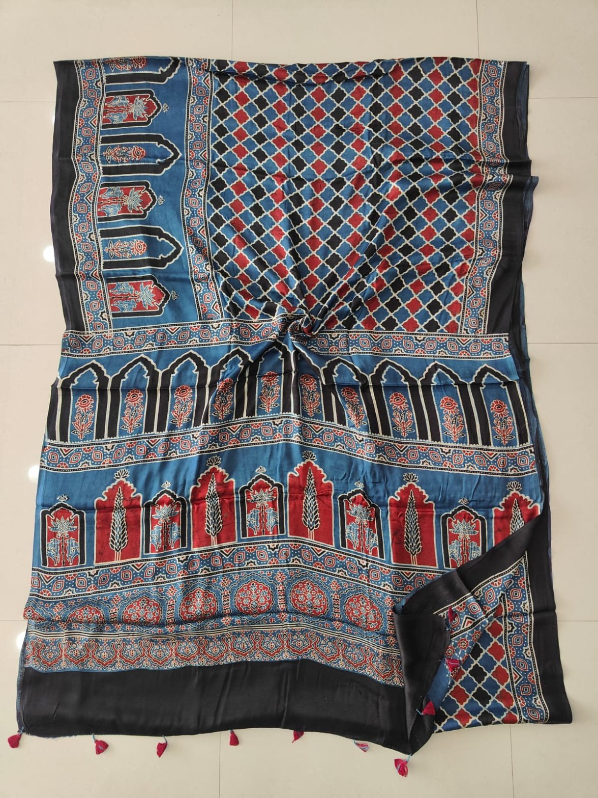 Blue Ajrakh print pure modal silk saree with diamond lattice and temple arch motifs, black border, pink tassels