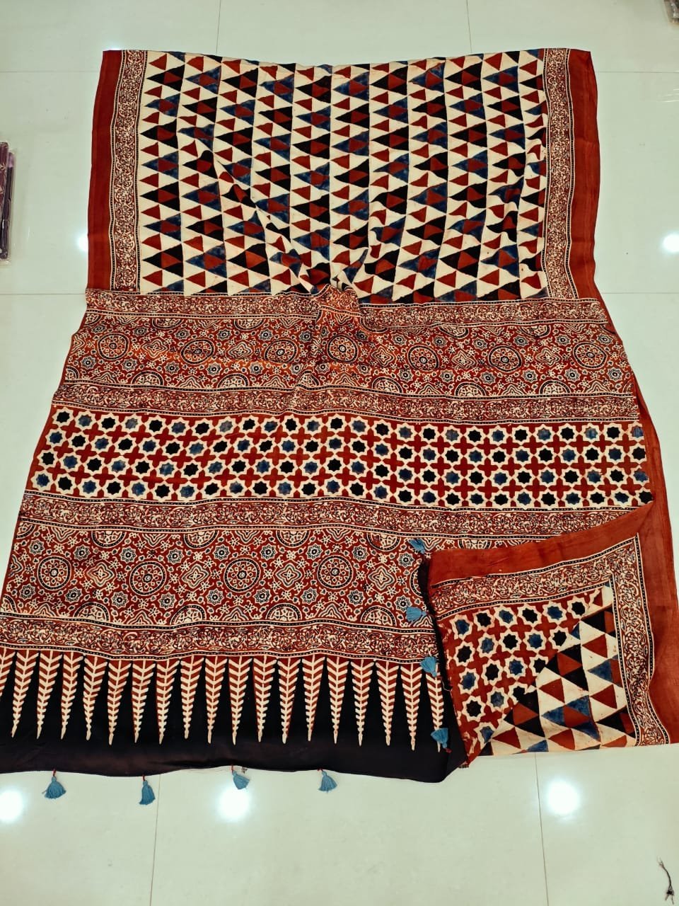 Maroon and black Ajrakh print pure Modal silk saree with triangular lattice and leaf border pallu