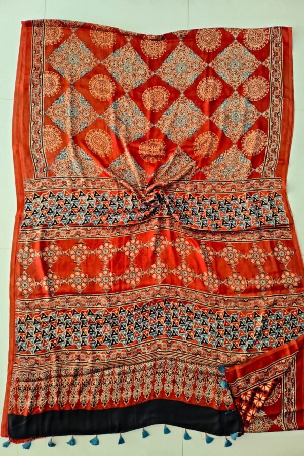 Rust red Ajrakh print pure Modal silk saree with diamond lattice and black tasseled border