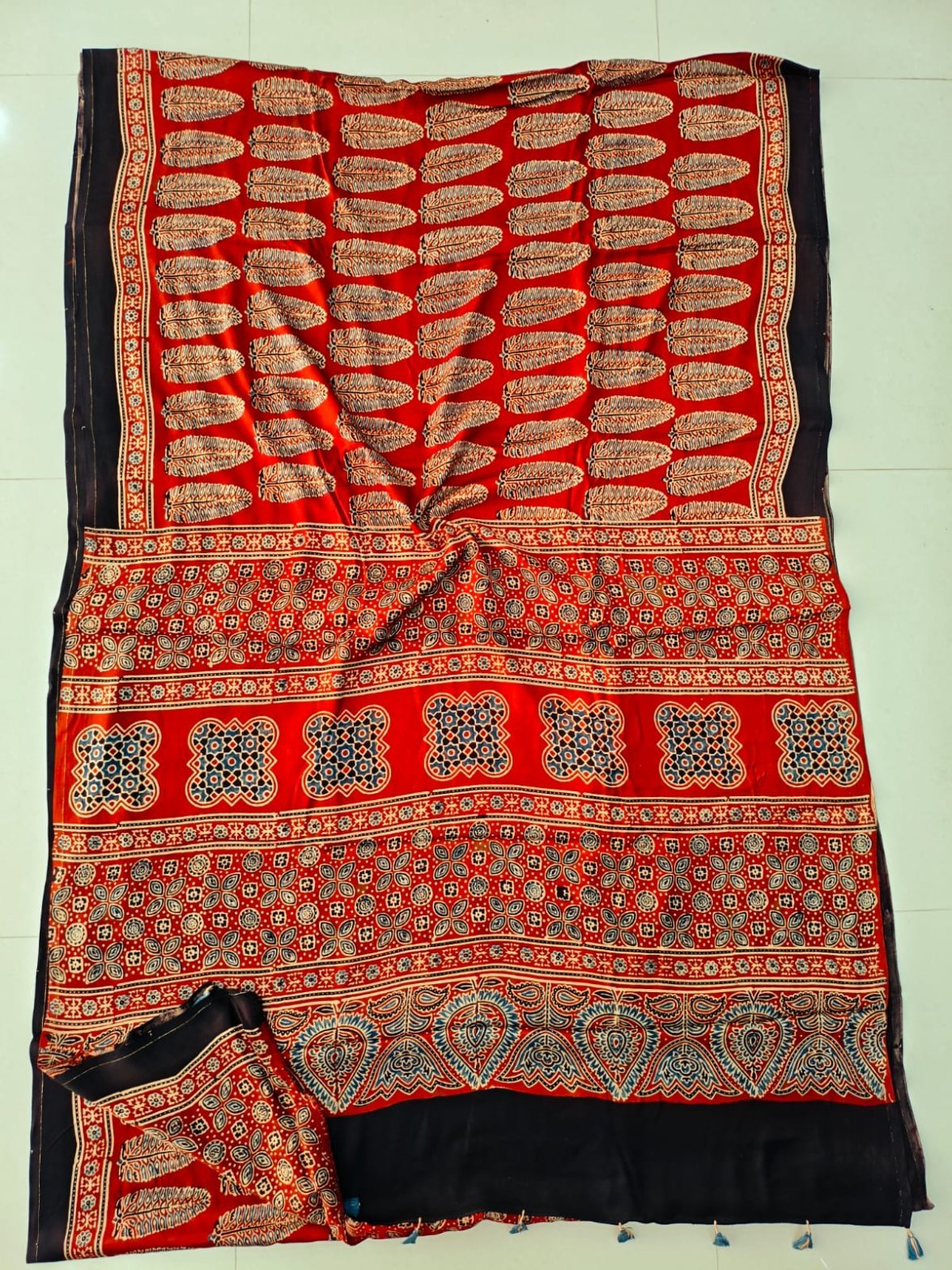 Red and black Ajrakh print Pure Modal Silk saree with feather motifs and leaf border pallu