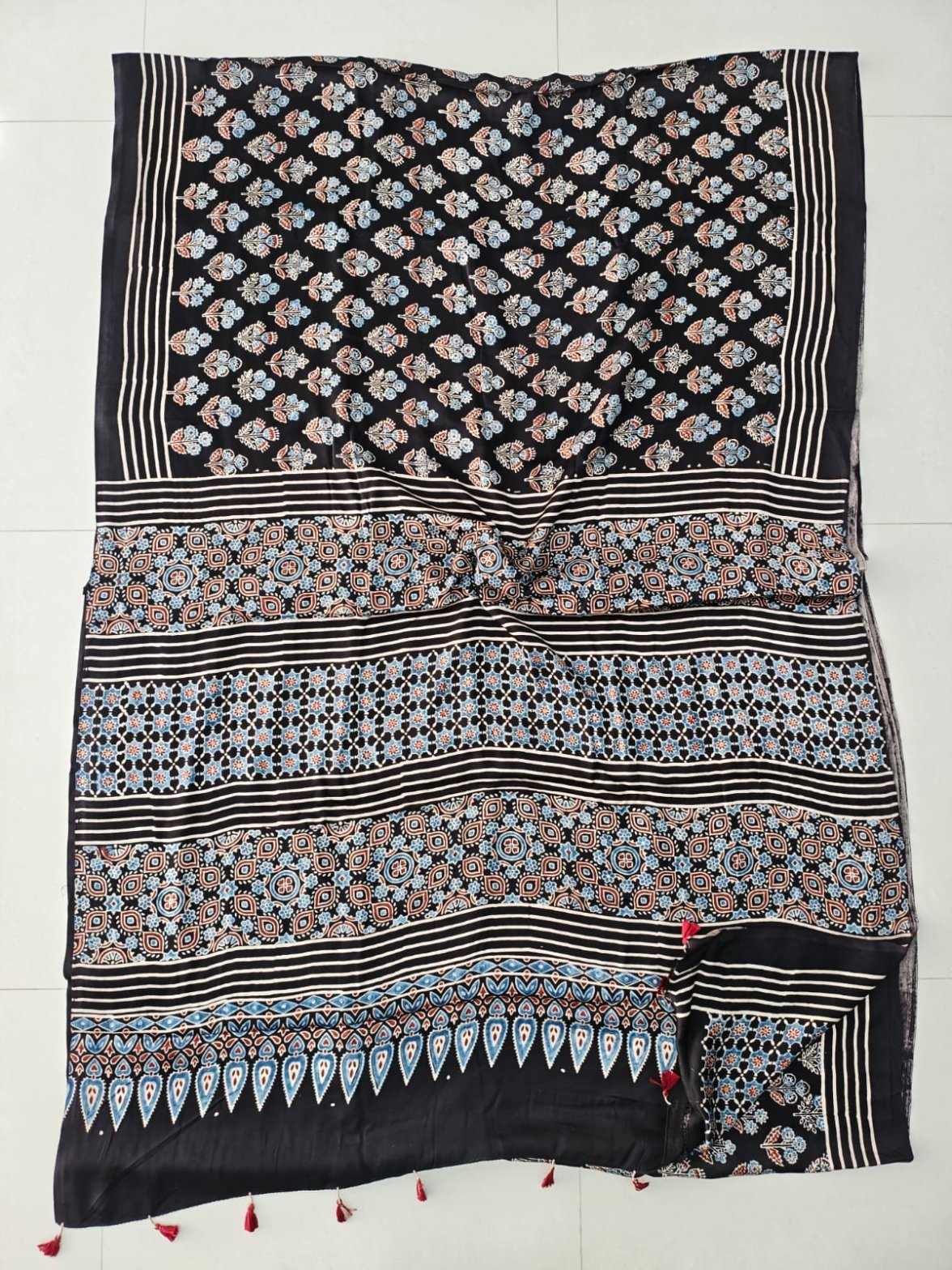Black Ajrakh print Modal silk saree with floral booti body and blue leaf border pallu