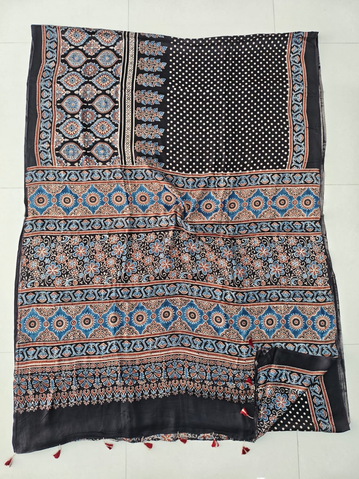 Black Ajrakh print Modal silk saree with polka dot body and blue medallion pallu border