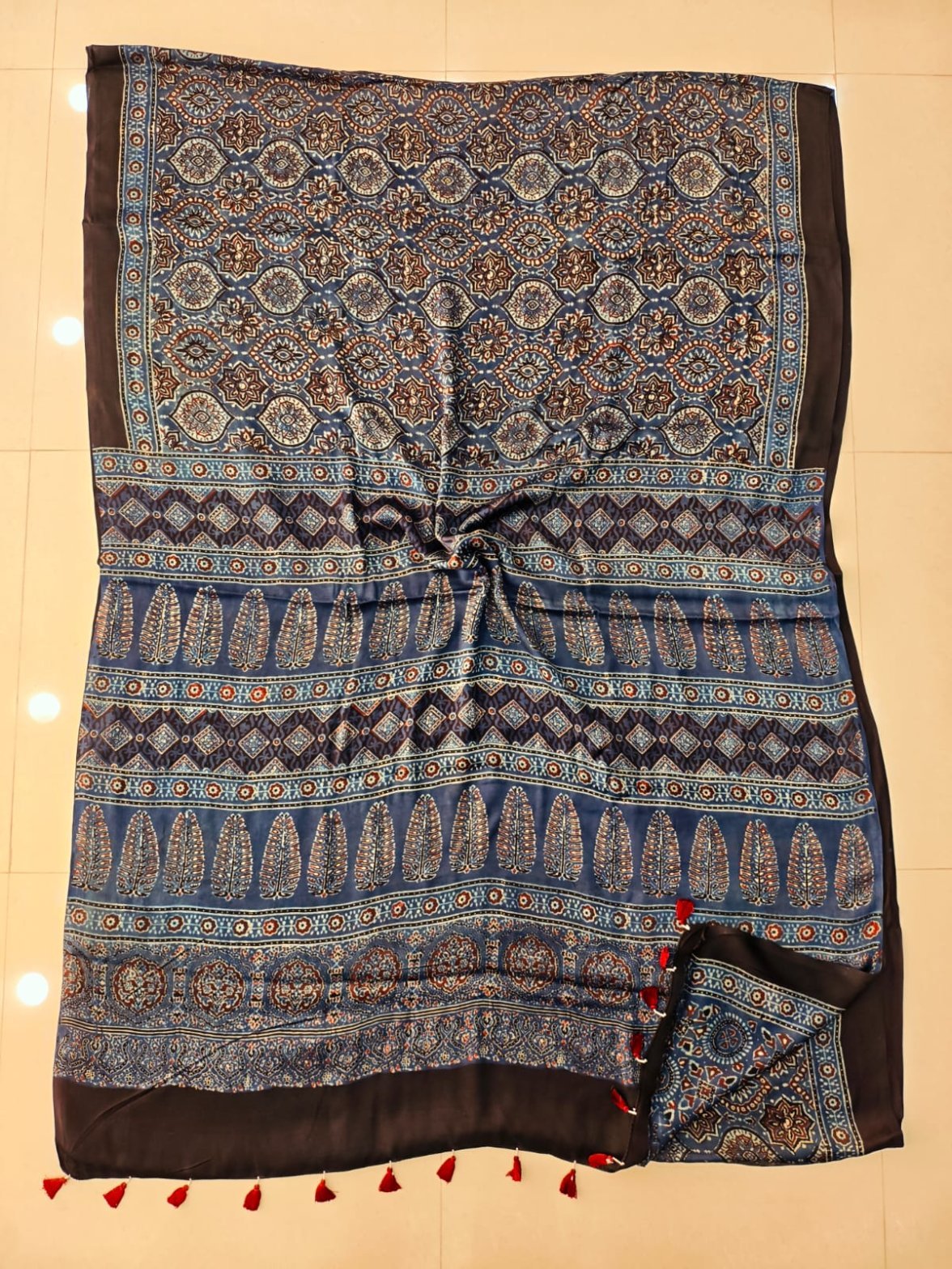 Blue and black Ajrakh print pure Modal silk saree with octagonal medallion body and feather motif pallu