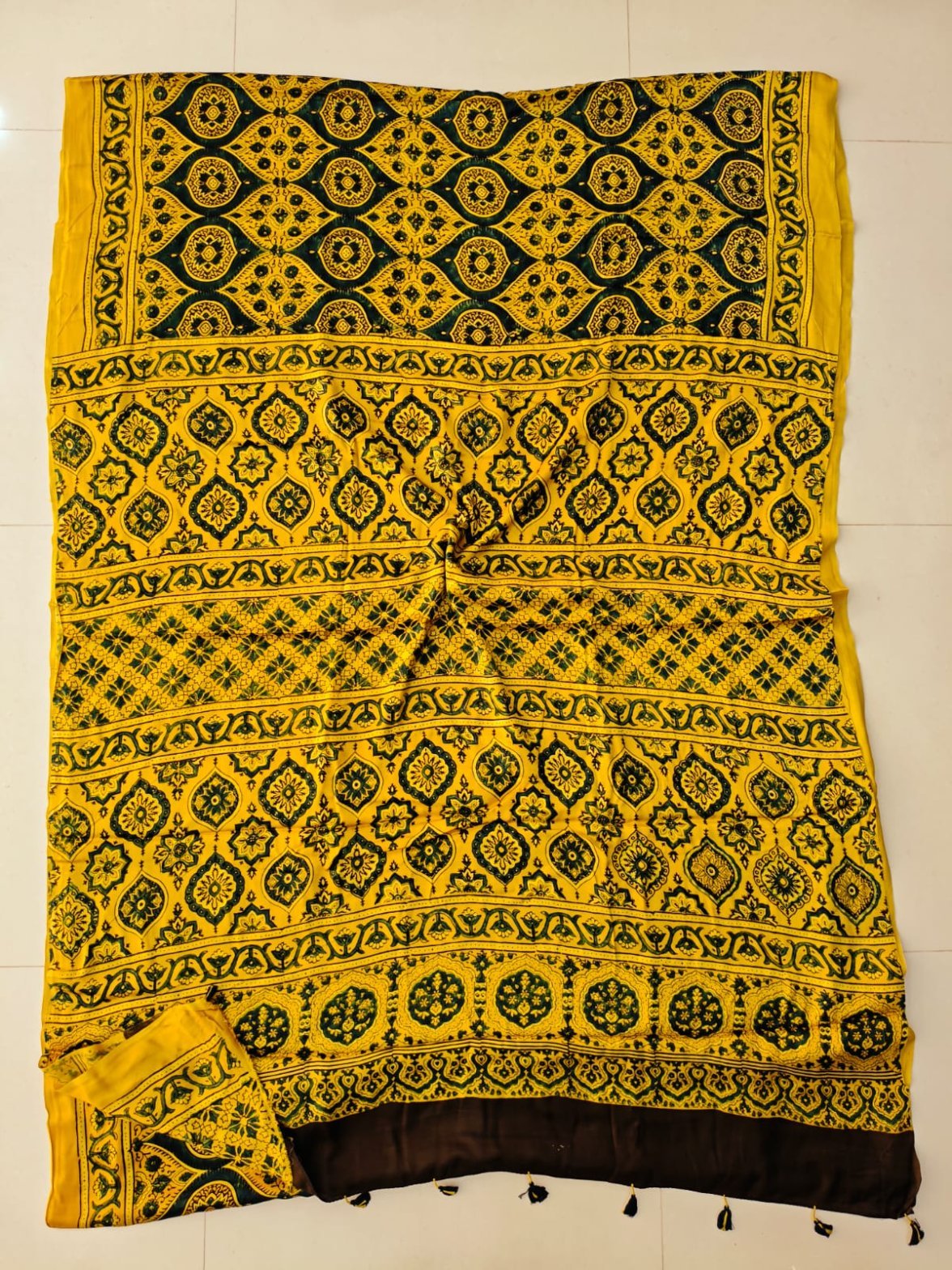 Yellow and black Ajrakh print pure Modal silk saree with medallion lattice pallu and tasseled border