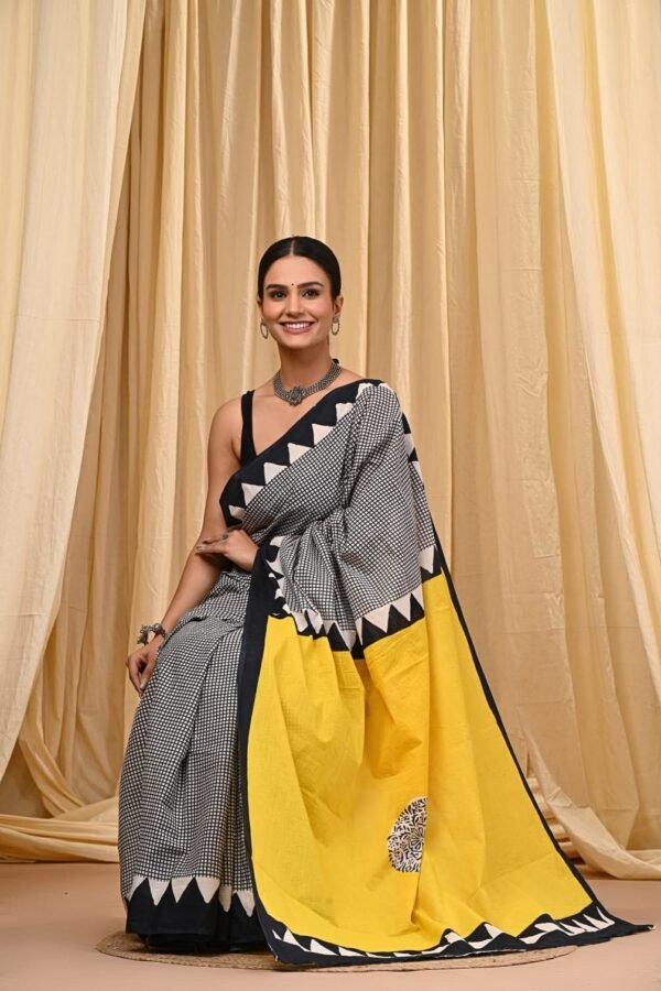 Woman wearing black and white checkered Bagru print mul cotton saree with yellow pallu