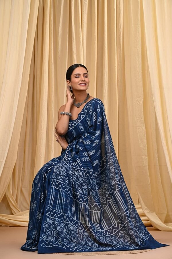 Woman draped in indigo blue Bagru print mul cotton saree with geometric patchwork motifs