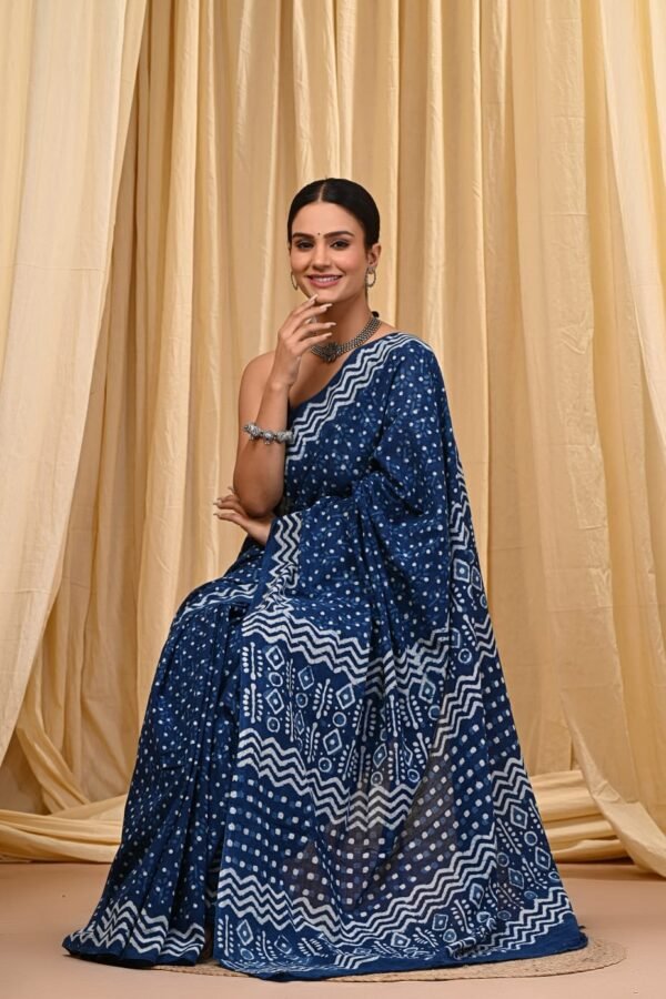 Woman draped in indigo blue Bagru print mul cotton saree with white polka dots and zigzag border