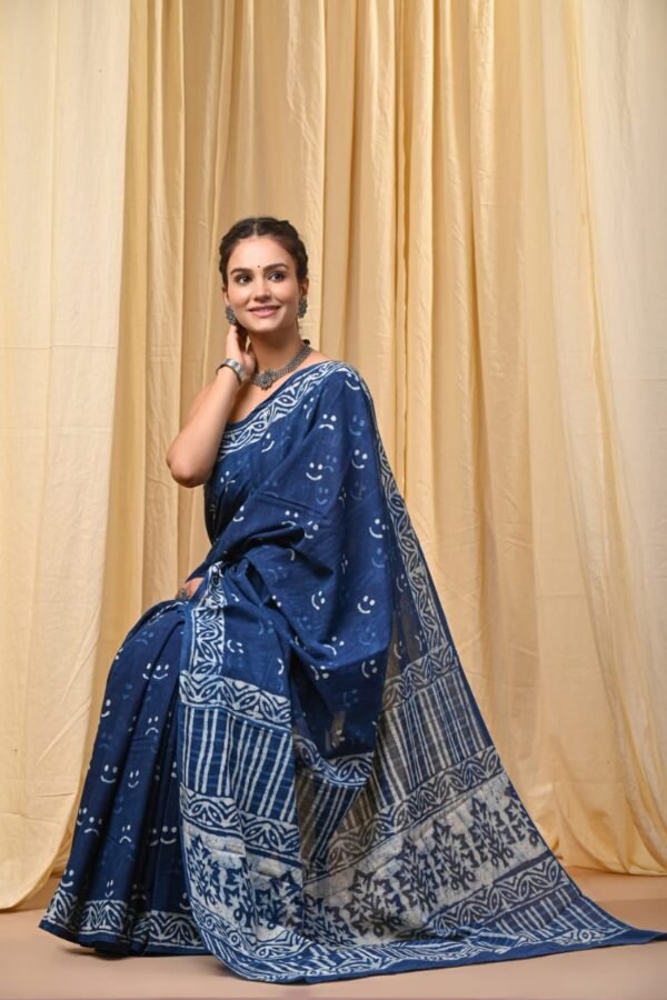 Woman draped in indigo blue Bagru print mul cotton saree with crescent motifs and striped border