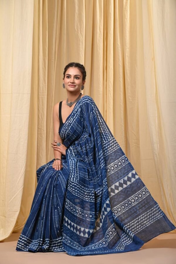 Woman draped in indigo blue Bagru print mul cotton saree with zigzag and scalloped border motifs