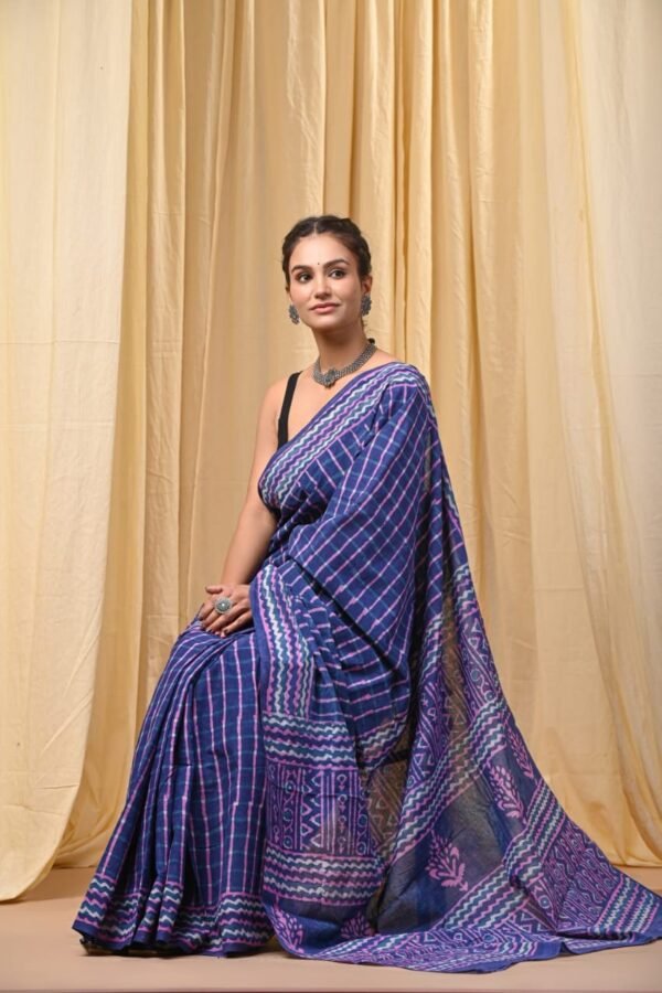 Woman draped in purple and blue checkered Bagru print mul cotton saree with zigzag border