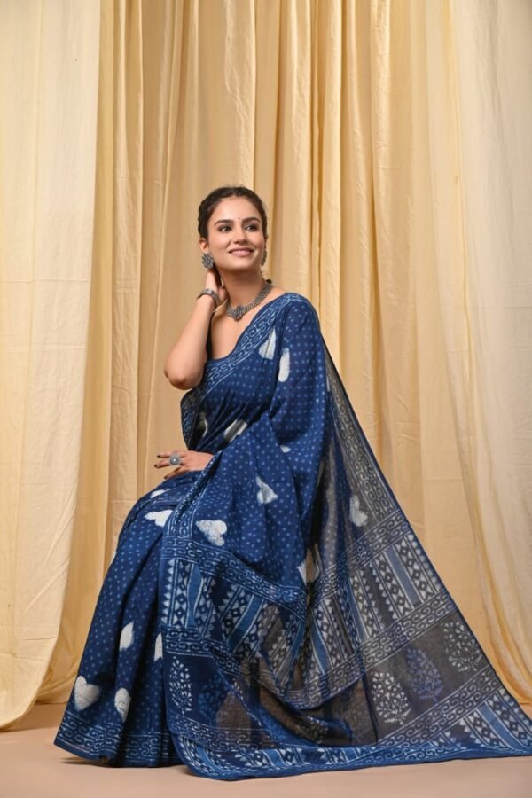 Woman draped in indigo blue Bagru print mul cotton saree with white dot and leaf motifs