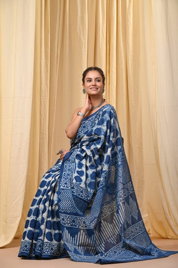 Woman draped in indigo blue Bagru print mul cotton saree with circle motifs and zigzag border