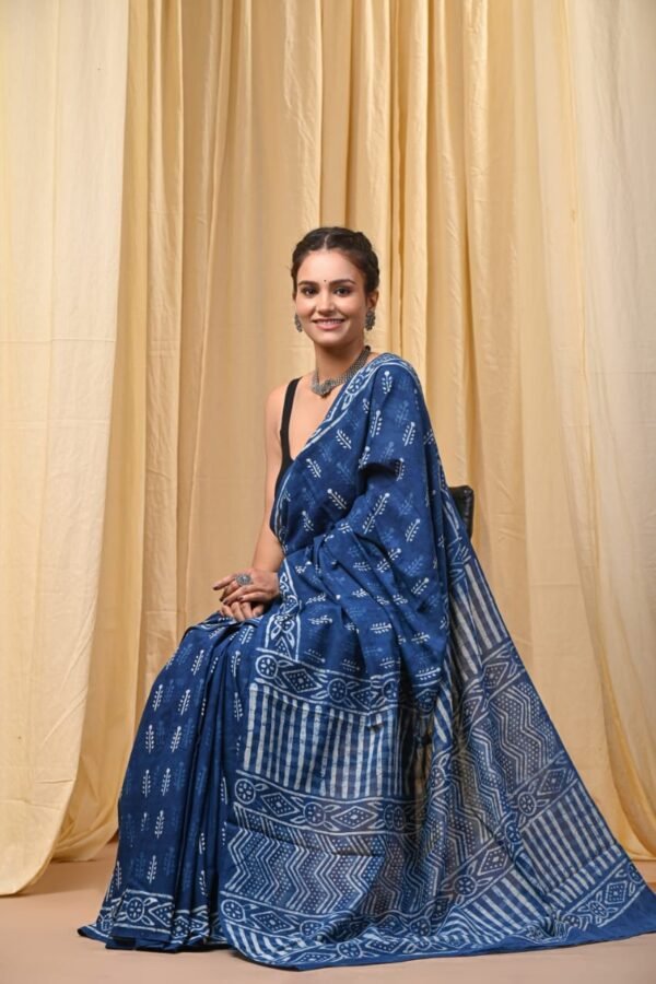 Woman draped in indigo blue Bagru print mul cotton saree with sprig motifs and striped border