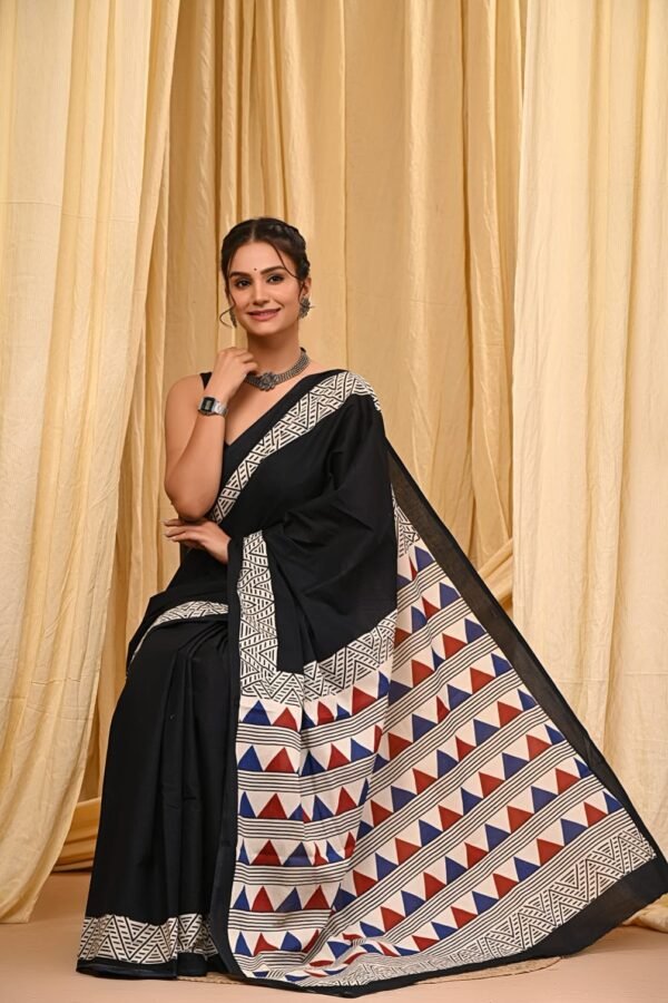Woman wearing black mul cotton Bagru print saree with white zigzag and triangle border