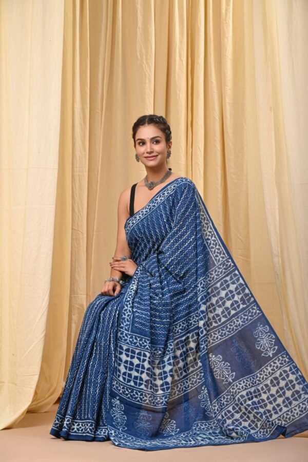 Woman wearing indigo blue Bagru print mul cotton saree with floral lattice border