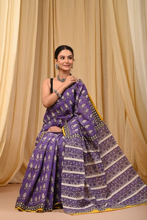 Woman draped in purple Bagru print mul cotton saree with bird motifs and striped border