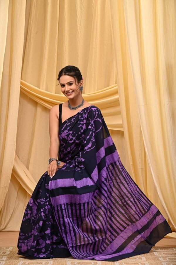 Woman in purple and black Bagru print mul cotton saree with crackle pattern and striped border