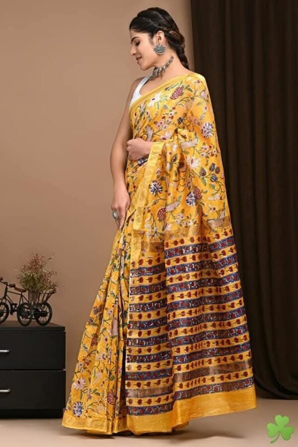 Woman draped in mustard yellow hand block printed Maheshwari silk saree with navy floral border