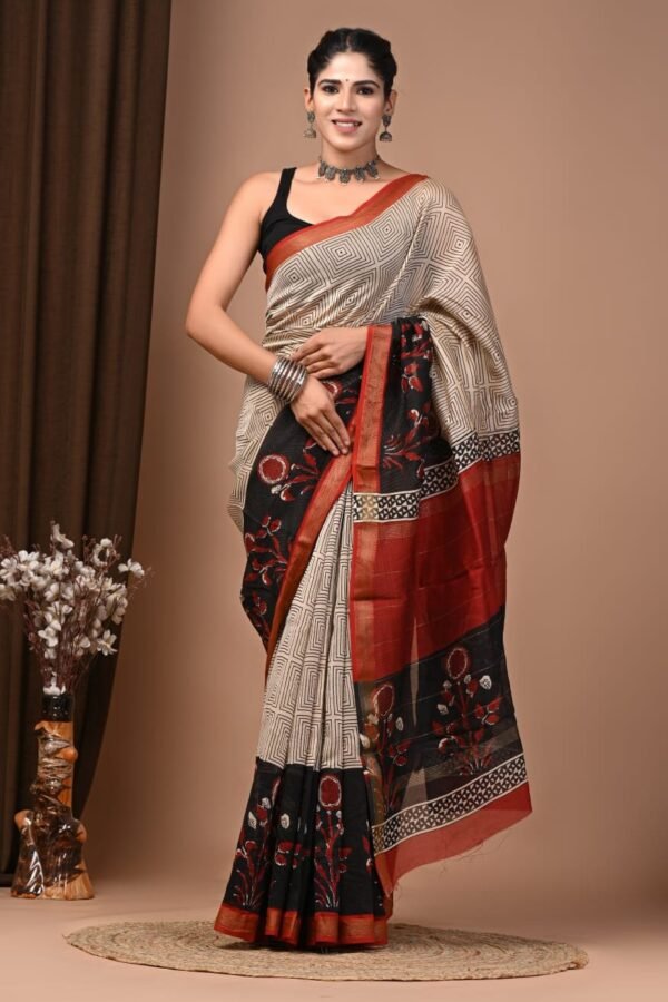 Woman wearing cream geometric hand block printed Maheshwari silk saree with black floral border