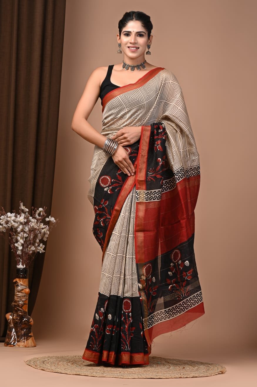 Woman wearing cream geometric hand block printed Maheshwari silk saree with black floral border