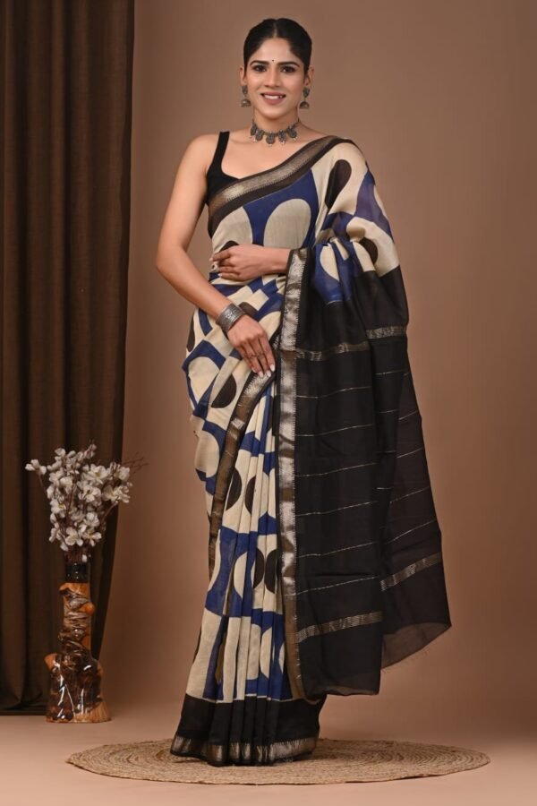 Woman wearing navy blue and beige geometric hand block printed Maheshwari silk saree with black zari border