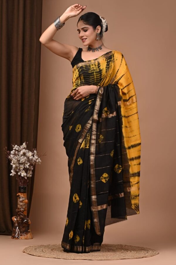 Woman wearing black and yellow Shibori hand block printed Maheshwari silk saree with zari border