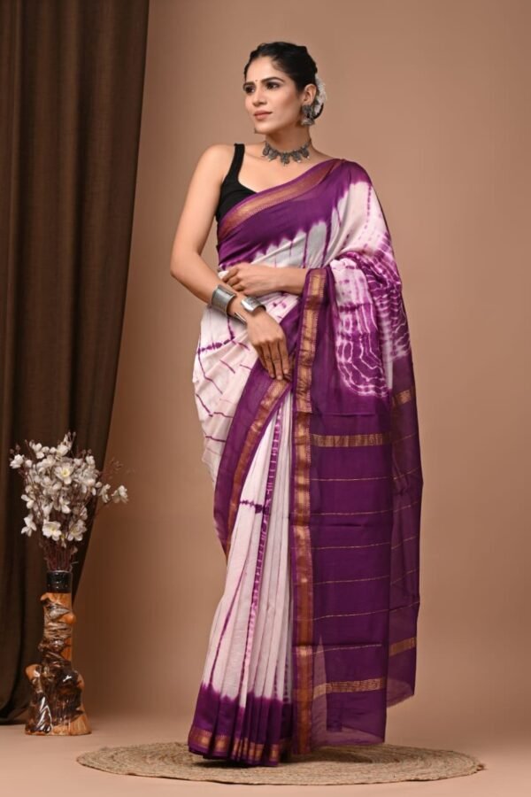 Woman draped in purple and white Shibori print Maheshwari silk saree with gold zari border