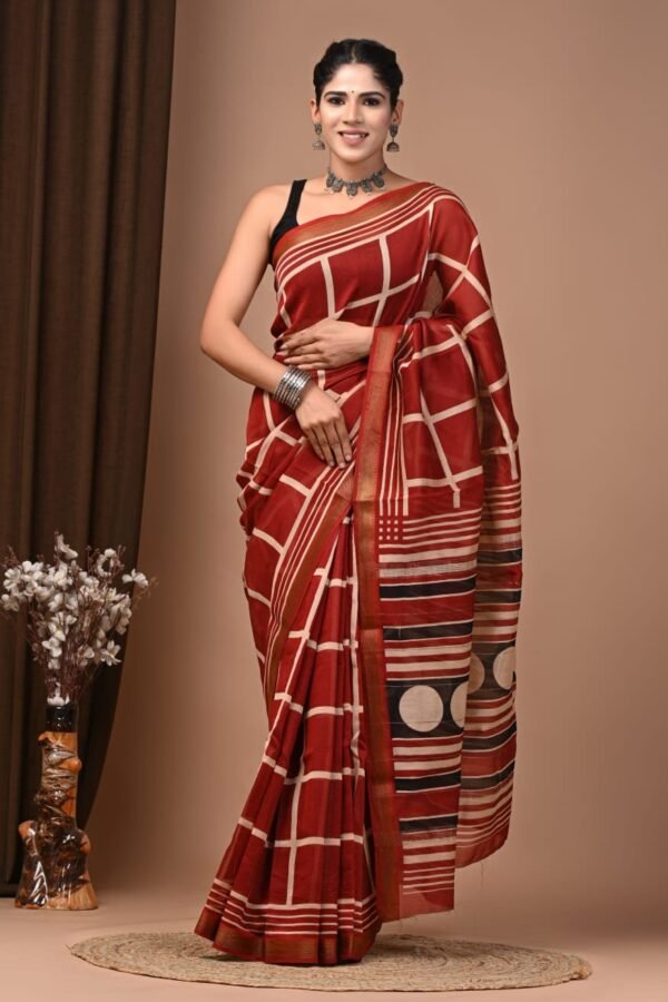 Woman wearing rust red and beige checked hand block printed Maheshwari silk saree with striped pallu