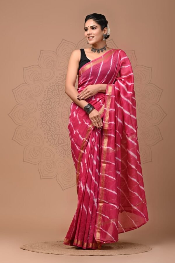 Woman draped in pink Shibori hand block printed Maheshwari silk saree with gold zari border