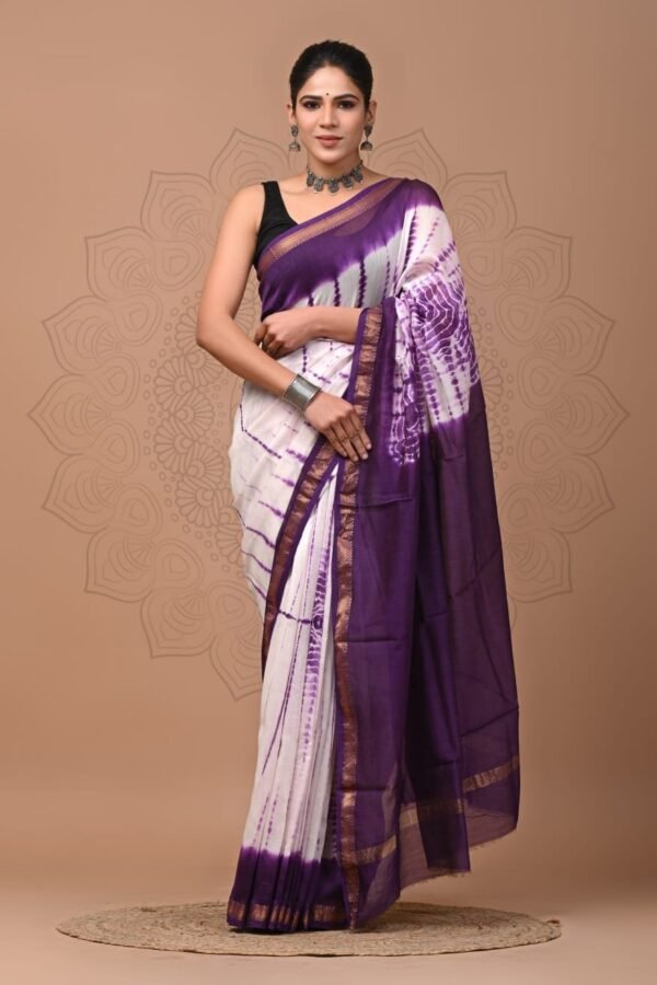 Woman wearing white and purple shibori tie-dye Maheshwari silk saree with gold zari border