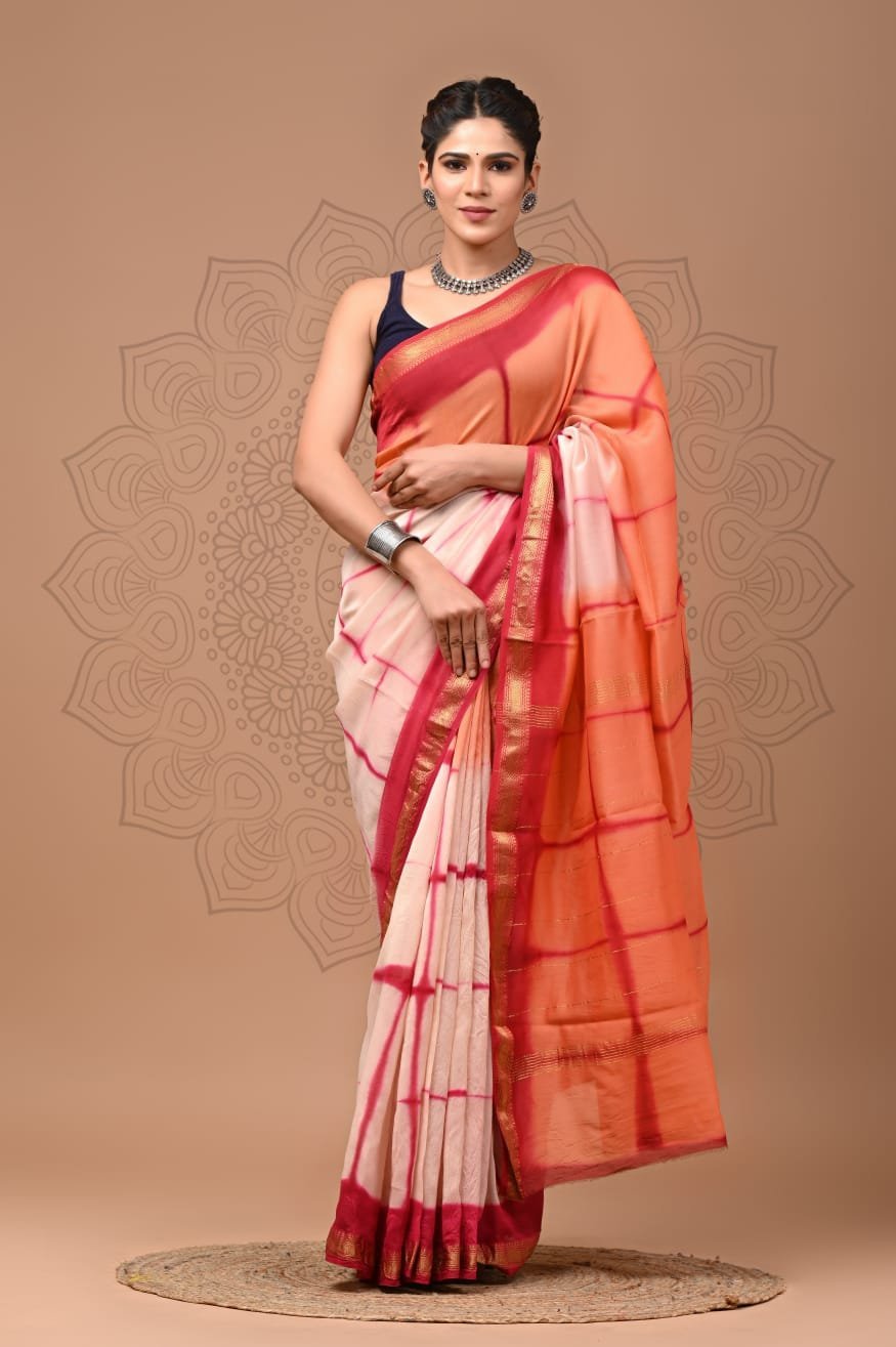 Woman wearing off-white Maheshwari silk saree with pink checkered print, orange pallu, and gold zari border
