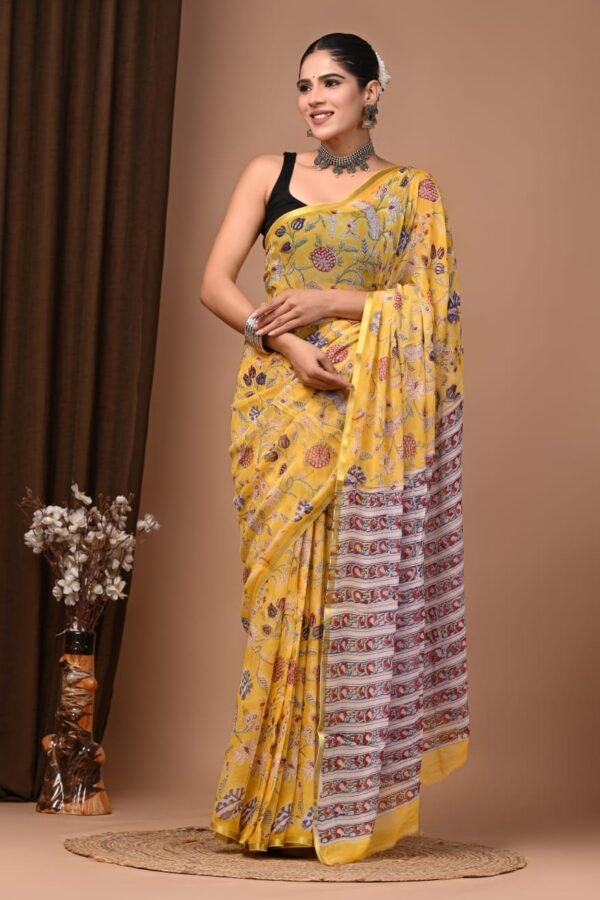 Woman wearing yellow hand block printed chiffon saree with floral motif and striped pallu border