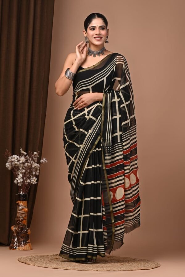 Woman wearing black hand block printed chiffon saree with geometric grid pattern and striped pallu border