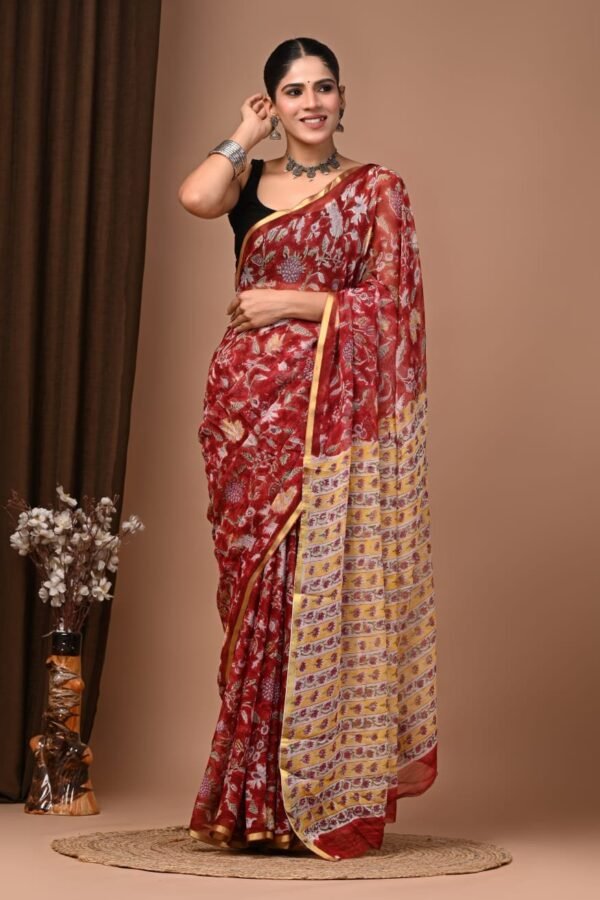 Woman draped in maroon hand block printed chiffon saree with floral motif and mustard striped pallu border
