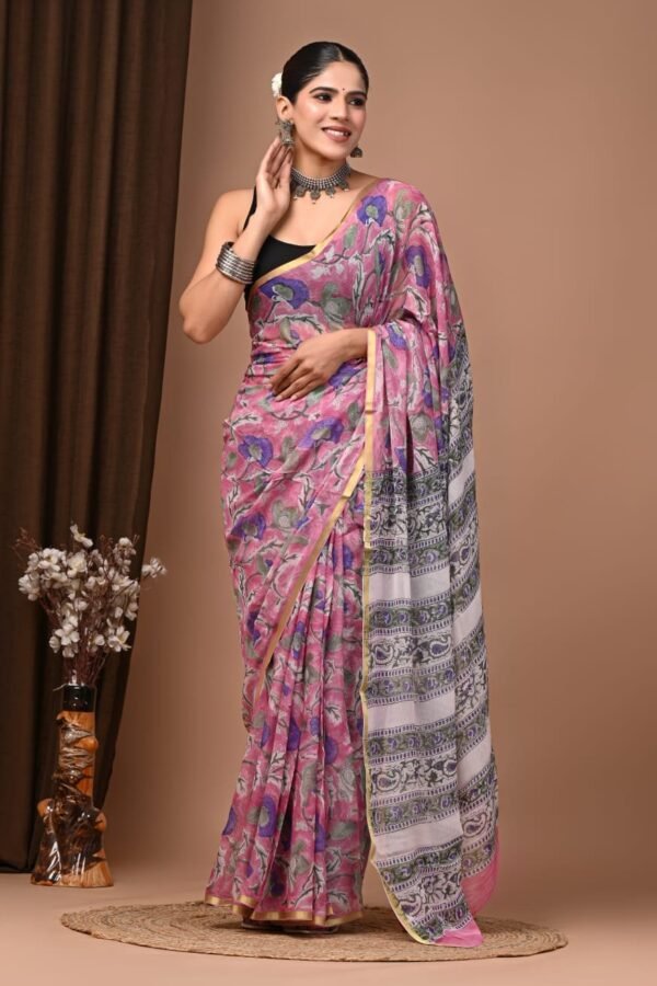 Woman draped in pink hand block printed chiffon saree with floral motif and striped pallu border