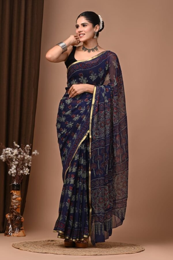 Woman wearing navy blue hand block printed chiffon saree with floral motif and golden border