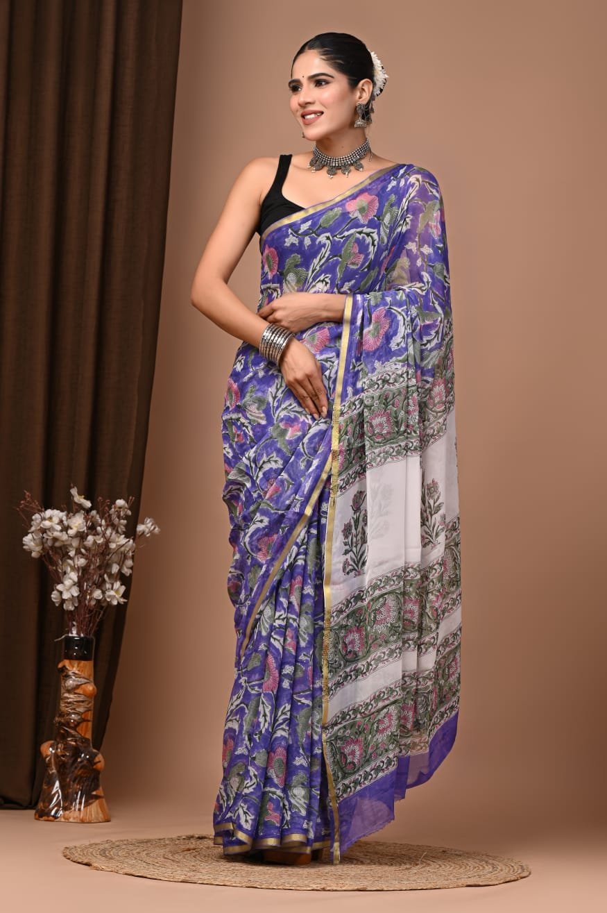 Woman in violet-blue hand block printed chiffon saree with floral motif and ivory border