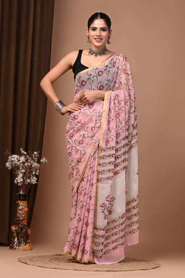 Woman wearing pink hand block printed chiffon saree with floral motif and striped border