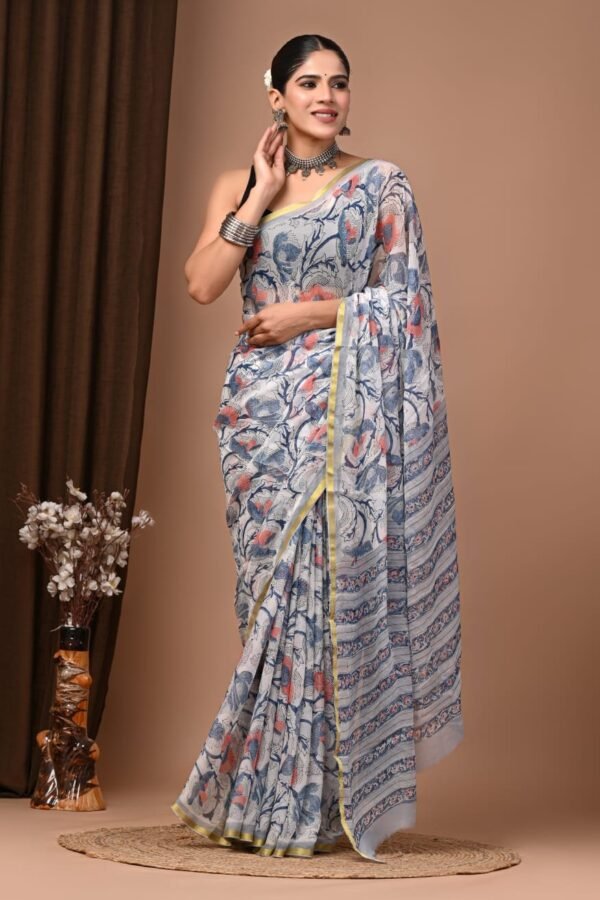 Woman wearing white hand block printed chiffon saree with blue floral vine motif and striped pallu border