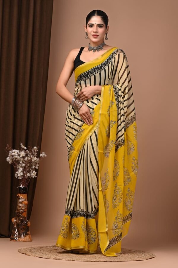 Woman wearing cream hand block printed chiffon saree with black diagonal stripes and yellow floral pallu