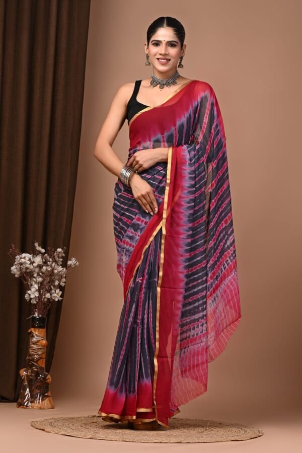 Woman wearing grey and red hand block printed shibori chiffon saree with golden zari border
