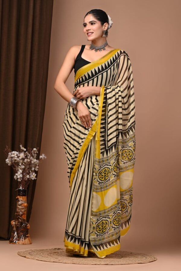 Cream hand block printed chiffon saree with black stripes, zigzag chevron border, and medallion pallu