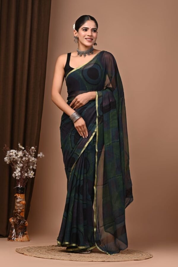 Woman draped in dark green-blue hand block printed double diamond chiffon saree with golden border