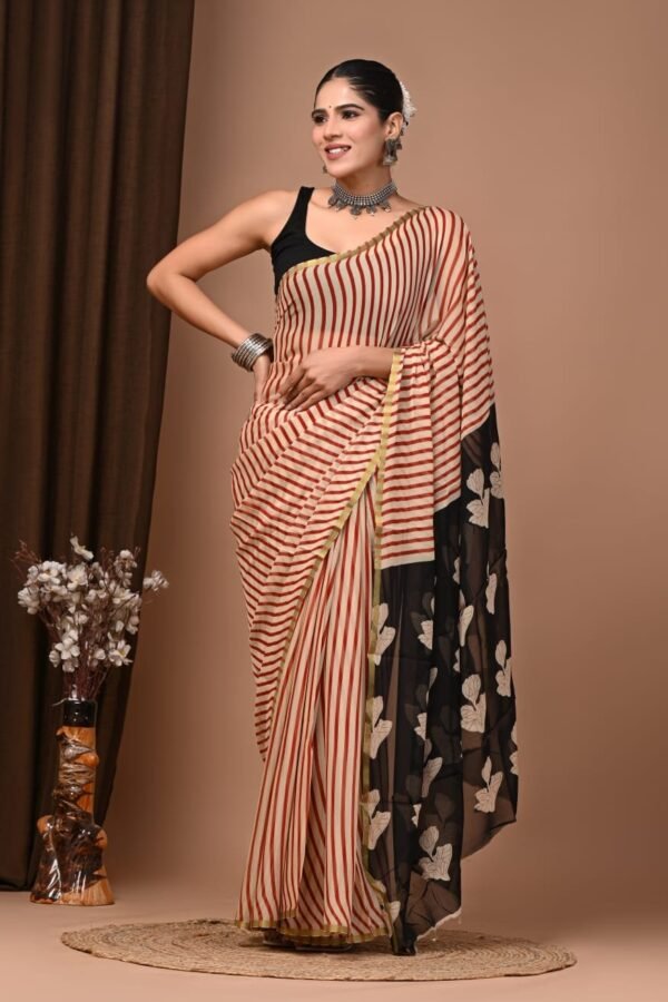 Woman wearing rust-red striped hand block printed chiffon saree with black floral pallu