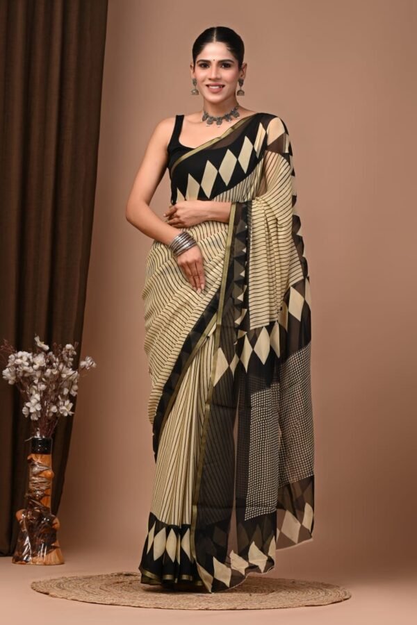 Woman wearing cream and black striped hand block printed chiffon saree with diamond border pallu